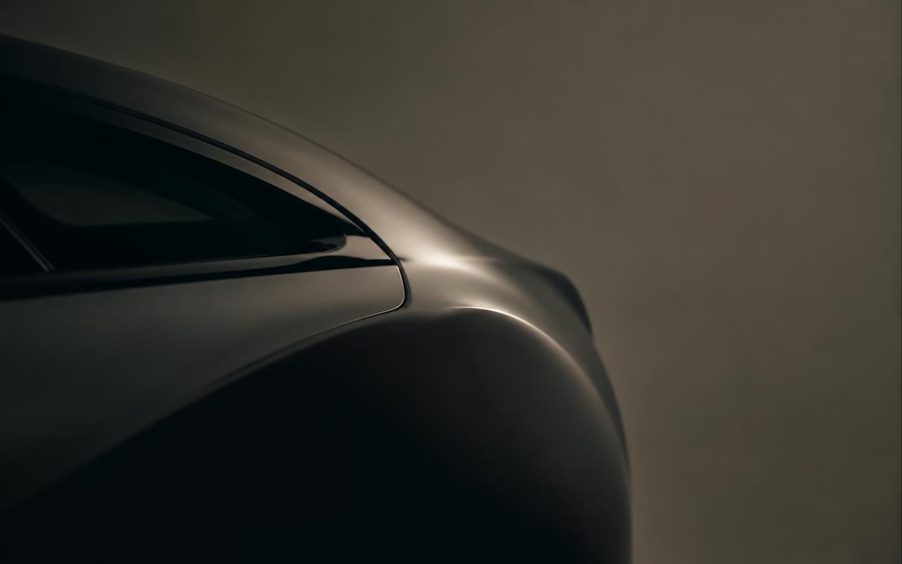 Illustrative image: close-up of a dark car body curve in soft studio light